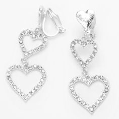 Keep up with the latest trend of earrings with no piercings necessary! These drop earrings feature two faux crystal embellished hearts hanging from each clip on heart post. Finish: Silver-tone Drop: 1.5" Closure: Clip on Material: Metal - Claire's Silver 1.5" Triple Heart Clip On Drop Earrings Valentines Dance, Claires Earrings, Claire's Accessories, Heart Clip, Triple Heart, Pretty Jewelry Necklaces, Cheap Earrings, Woman Jewelry, Silver Heart Earrings