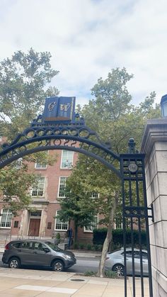 a car is parked in front of an iron gate