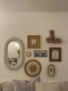 a living room filled with furniture and framed pictures on the wall above a white couch