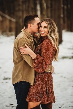 an engaged couple cuddles in the snow during their winter engagement session at pine creek state park