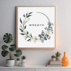 a white wall with some plants on it and a sign that says wreath