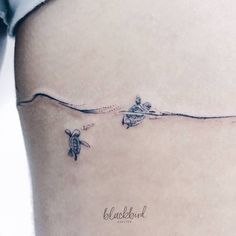 two small turtles swimming in the water on a woman's side ribcage