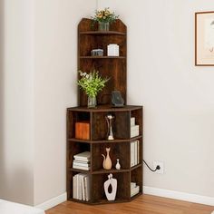 a corner shelf with books, vases and other items on it in a living room