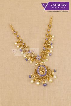 Maa Lakshmi Devi Design Gold Necklaces are seen online. Traditional designs of gold necklaces are seen in a fascinating and elegant manner. These 916 hallmark jewellery are so charming with the unique gemstone touch. Pearls and gemstone necklaces are 33 grams in weight. #goldjewellery #goldnecklaces #womenjewellery #stonejewellery #goldneckwearwomen #womennecklaces #fancystonejewellery #necklaces #czjewellery #fancystonenecklaces #realgoldjewellery #freeshippingjewellery #onlinegoldshopping #customizationofstonenecklaces #rubynecklaces #whitestonenecklaces #giftnecklaces #parrotdesigngoldnecklaces #pachinecklaces #2tulagoldnecklaces #uniquenecklacesingold #diamondnecklaces #diamondjewellery #cznecklaces #necklacesingold #womenjewellerystyles #stylishjewellery Lakshmidevi Earrings, Pearl Gold Necklace Indian, Stone Necklace Designs, Necklace Designs Gold Indian, Hallmark Jewellery, Indian Gold Necklace Designs, Maa Lakshmi, Pearl Gold Necklace, Purple Stone Necklace