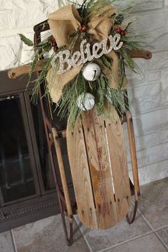 a wooden sled with christmas decorations on it and the word believe spelled in white letters