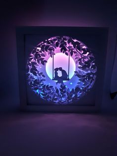 an illuminated photo frame with a couple kissing in the moonlight