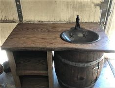 an old wooden sink and barrel in a room