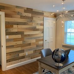 a dining room with wood paneling on the walls and a table in front of it