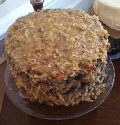 two cakes sitting on top of a glass plate next to a cupcake and cake server