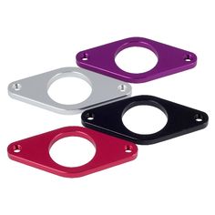 three different colored metal parts on a white background