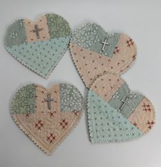 four hearts with crosses on them sitting next to each other