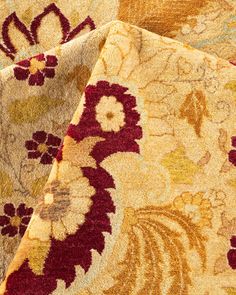 closeup of an area rug with red and yellow floral designs on the bottom half