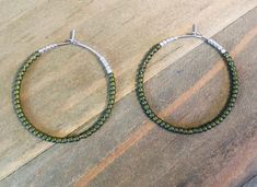 *Medium Sized Hoops *1 1/8 inches in diameter  *Fine Glass Seed Beads *Silver Plated  *Four Colors These cute hoop earrings are perfect for this time of year! They come in cranberry, olive,  dark rainbow, and olive gold.  Get your fall wardrobe ready with these hoops.  They are little over an inch and silver plated.  The dainty hoops are made with very fine glass seed beads. ~I use high quality hypoallergenic materials along with many different colors and types of beads.  I work hard to create beautiful pieces and to provide excellent customer service.   Packaging All of my earrings come packaged in a pretty drawstring  organza bag with my deepest gratitude to all customers. They make perfect gifts. Other big hoops in the shop:  https://www.etsy.com/listing/1057593282/large-hoop-earrings-l Cute Hoop Earrings, Olive Earrings, Hoop Earrings Medium, Dark Rainbow, Medium Hoop Earrings, Multicolor Earrings, Earrings Beaded, Earrings Hoop, I Work Hard