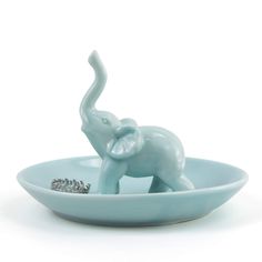 an elephant figurine is sitting in a bowl