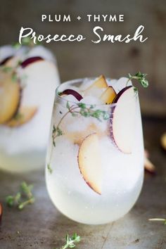 two glasses filled with ice and some fruit