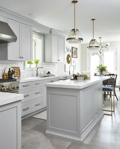 a kitchen with white cabinets and an island