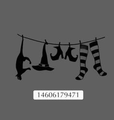 socks and hats hanging on a clothes line with the words halloween written in black ink