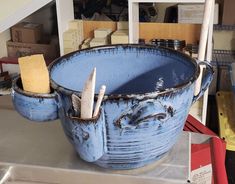 a large blue bowl with toothbrushes in it