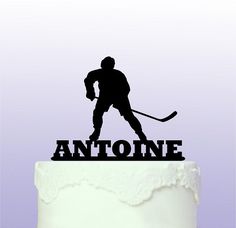 a cake topper that has a hockey player on it