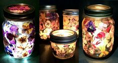 three jars with flowers painted on them and one has a lit candle in the middle