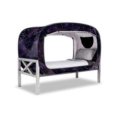 a small bed with a purple and white cover on it's headboard, sitting in front of a white background