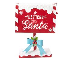 a red and white mailbox with a blue ribbon on it that says letters santa