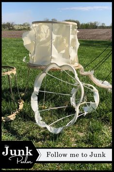 a white horse drawn carriage sitting on top of a lush green field