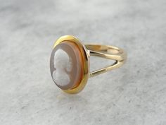 To complete this vintage ring, we've chosen an unusual, hefty cameo! This is a hard-stone cameo, a cameo carved not from shell, but from naturally banded agates, carnelians, or in this case, Sardonyx. The workmanship is detailed and lovely, and the simplicity of the gold setting allows the stone to be the centerpiece!Metal: 14K Yellow Gold Gem: Hardstone Cameo Gem Measurements: 13 x 9.5 mm Oval Ring Size: 9.25Marks: "14K A" Stamped on the inside bandSKU #: YPN3H7-NEach piece has been identified Bike Jewelry, Mens Ring Designs, Cameo Jewelry, Cameo Ring, Oval Ring, Metal Pendant, Men's Rings, Vintage Ring, Gold Set