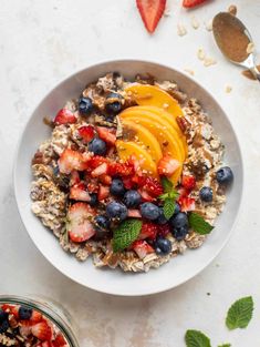 a bowl filled with oatmeal topped with fruit