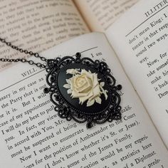 About This Item A Charming Rose, Delicate Large Cameo, And Mysterious Black Necklace - Ideal For Gothabilly, Victorian, And Long-Admirers Alike! Pendant Size: 2.75" Total Length: Approximately 19" 50s Jewelry, Juicy Couture Necklace, Chocolate Pearls, Clay Bead Necklace, Goth Necklace, Floral Pendant Necklace, 14k Yellow Gold Necklace, Victorian Goth, Clover Charm