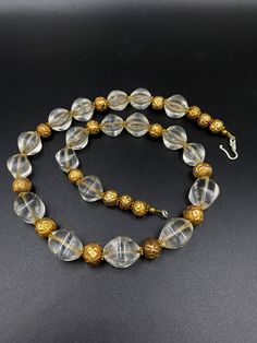 The Beautiful Crystals Quartz Beads Necklace Probably From Ancient Roman's or Greek's From Central Asian Countries Some Gold plated Wax and Some Brass Beads are Used As Spacers The Conditions Of Beads are Very Clearly Shown In the Pictures .Some Beads Got Some Damages that is due to Long Period Of times Price Is Negotiable So Please Do not Hesitate To Make an Offer Fast and Free Shipping Enjoy Beads Formal Gold Beaded Necklaces, Gold Beaded Necklaces With Spacer Beads For Formal Occasions, Gold Beaded Necklace With Gemstone For Costume Jewelry, Gold Costume Jewelry Beaded Necklaces With Gemstones, Gold Crystal Necklace With Large Round Beads, Formal Round Beaded Necklace With Spacer Beads, Gold Faceted Bead Crystal Necklace, Elegant Gold Faceted Beads, Elegant Gold Polished Beads, Gems, And Cabochons