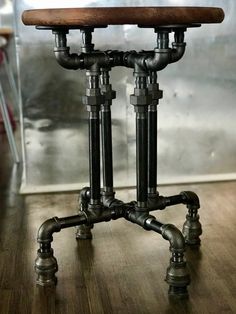 an old fashioned wooden stool with pipes attached to it