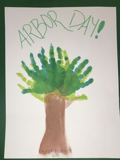 a child's handprint tree with green leaves and the words arbor day written on it