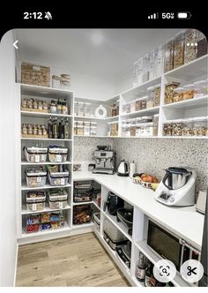 a kitchen with lots of shelves filled with food