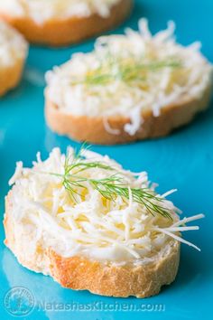 some food is sitting on a blue plate and has sprinkled parmesan cheese