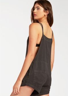 Play all day, dream all night. A laid-back take on the short overall, the Wild Pursuit features a vintage washed and well-worn woven fabric with classic overall pockets. A blend of playsuit and overalls, details include a rolled hem and thin straps that tie at the front. Slash front pockets. Back patch pockets. Front bib pocket. Rolled hem. Adjustable tie-front straps. 60% Cotton, 40% Viscose. Model is wearing size M. Painters Overalls, Play All Day, Rolled Hem, Off Black, Overall Shorts, Billabong, Playsuit, The Wild, Woven Fabric