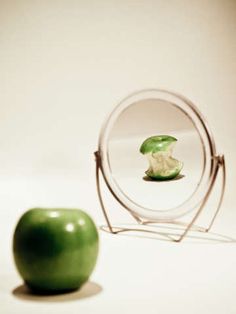 an apple is sitting in front of a magnifying glass with the image of an apple inside it