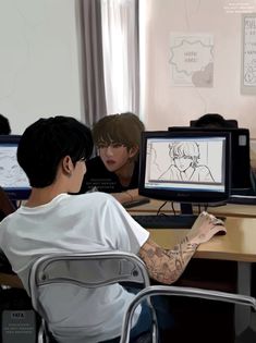 a man sitting at a desk in front of a computer monitor with a drawing on it