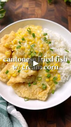 a white plate topped with rice and fried fish next to green onion garnish