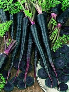 several bunches of purple carrots on a plate