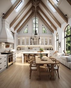 a large open kitchen and dining area with vaulted ceiling, white walls and wooden flooring