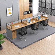 an office cubicle with two desks and chairs on the floor next to a potted plant