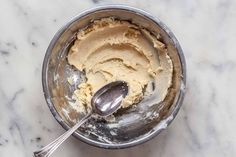 an ice cream in a metal bowl with a spoon