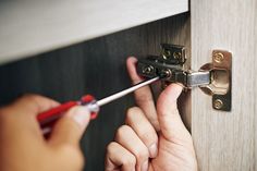 a person is working on a door handle