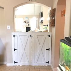 the inside of a house with two white doors and a mirror on the wall above it