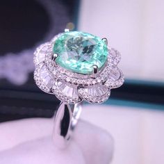 Rare Natural Paraiba Ring, Oval Cut 2.56ct Cyan Blue Tourmaline Ring with Real Diamonds, 18K solid White Gold, with CertificateThis 18k solid white gold ring is set with a marvelous 2.56ct Cyan Blue Tourmaline also called Paraiba with excellent fire and brilliance. The color of the Paraiba is a mysterious green-blue which is ultra rare and highly valued. This precious gem is surrounded with REAL diamonds on the band. This Ring is a wonderful piece of craftsmanship and one of a kind. The paraiba Luxury Oval Tourmaline Emerald Ring, Luxury Tourmaline Ring With Center Stone, Oval Aquamarine Diamond Ring Fine Jewelry, Oval Aquamarine Diamond Ring In Fine Jewelry Style, Gia Certified Oval Aquamarine Jewelry, Luxury Oval Emerald Ring With Moissanite, Elegant Oval Tourmaline Emerald Ring, Oval Tourmaline White Gold Rings, Luxury Oval Tourmaline Ring