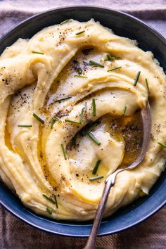 mashed potatoes in a blue bowl with a spoon