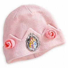 a pink beanie hat with an image of princess on the front and two flowers on the back