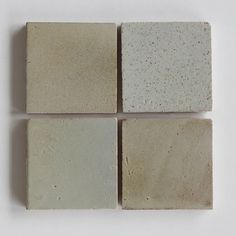 four white and beige tiles arranged on top of each other