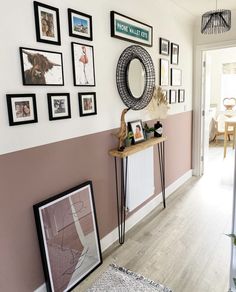 a hallway with pictures and frames on the wall